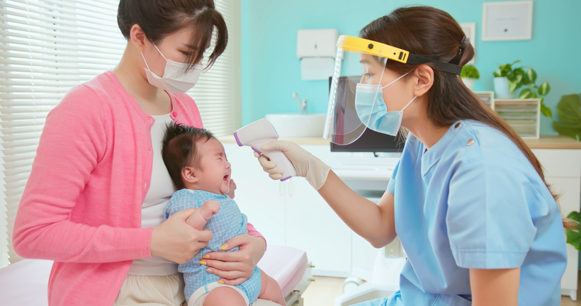 Asian Doctor Examine Baby Fever